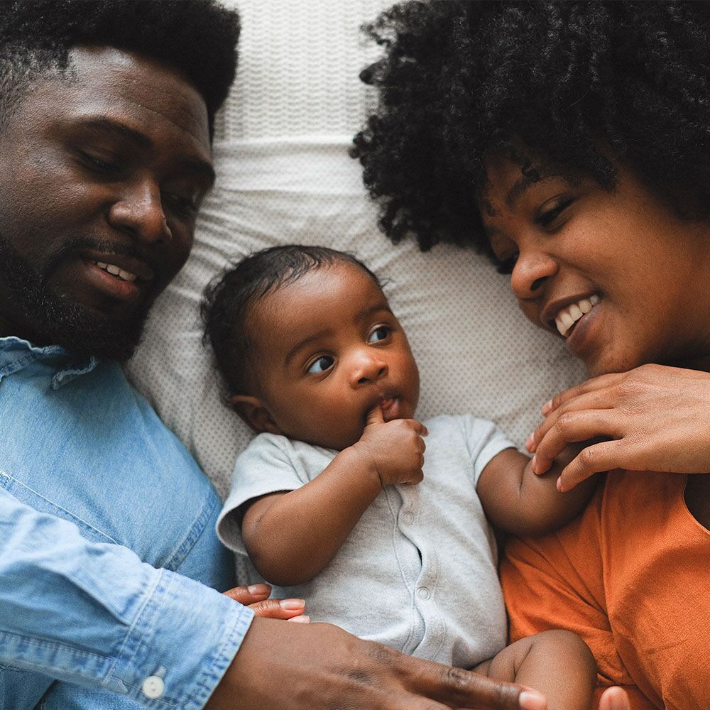 A family moment with a baby and parents sharing a loving interaction.